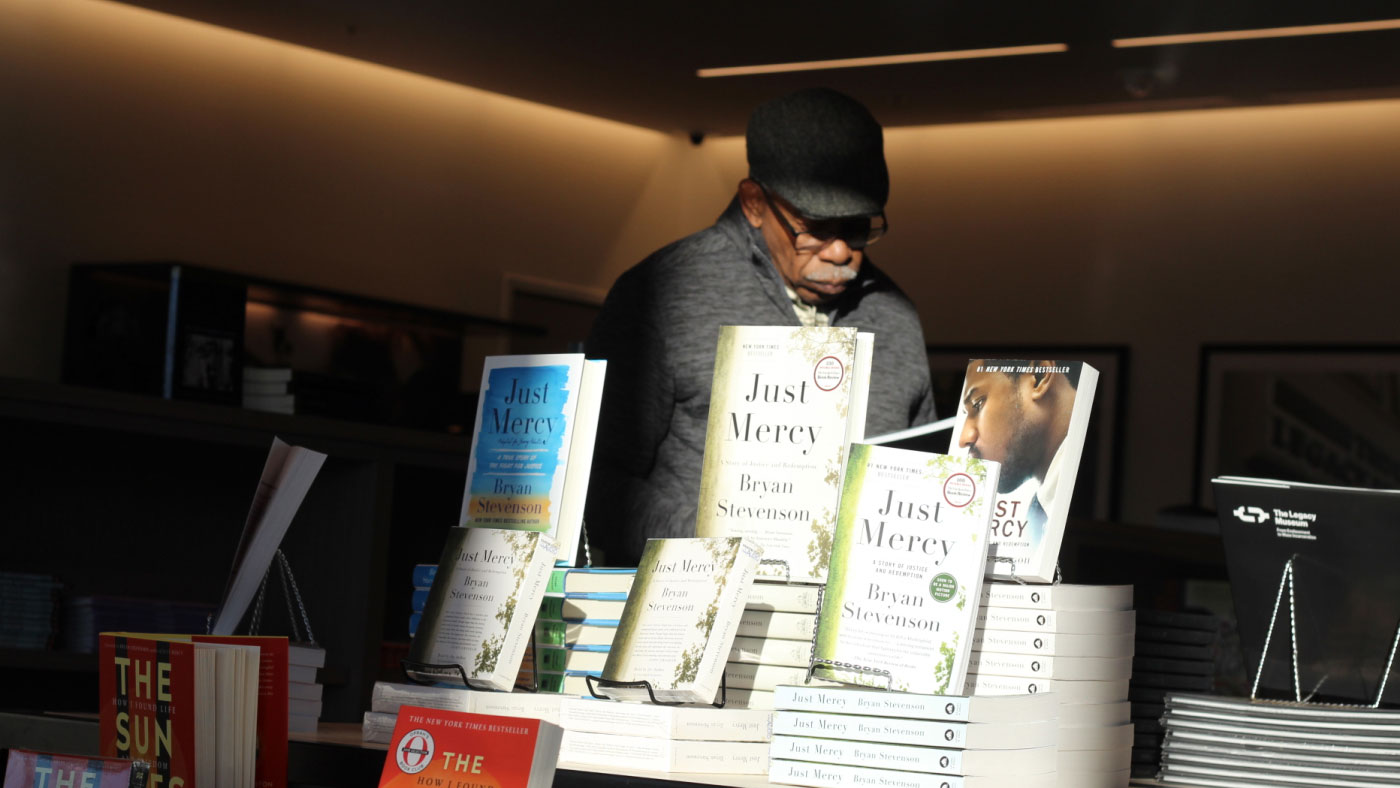 A man browses the carefully curated selection at our museum bookstore.