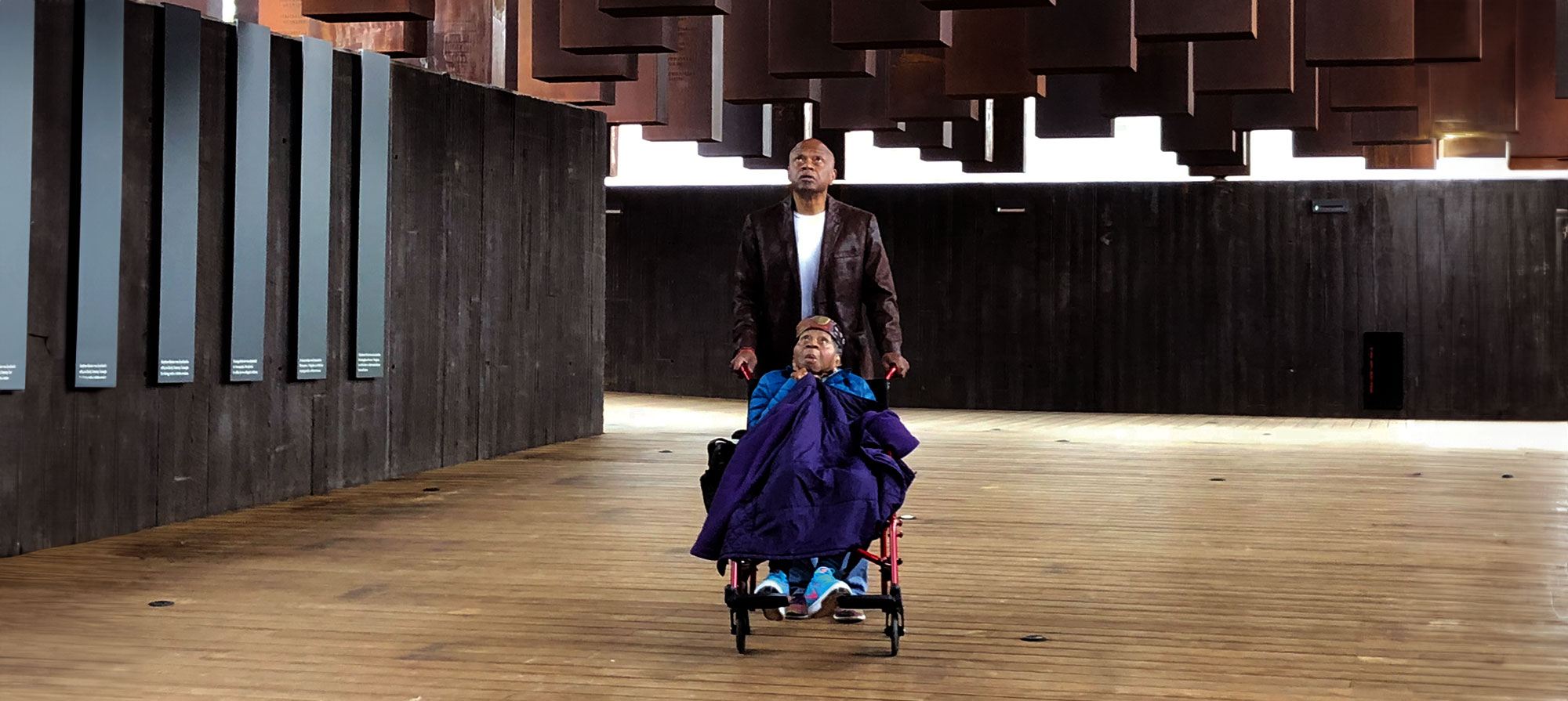 Mamie Kirkland, 109 years old, visits the National Memorial using a wheelchair pushed by her son, Tarabu Kirkland, in 2018.