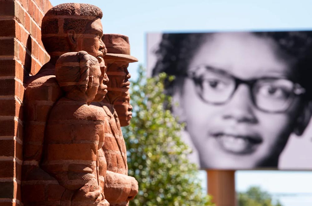 A brick sculpture dedicated to the leaders and participants in the Montgomery Bus Boycott, with Claudette Colvin's picture on the large billboard that provides information about local civil rights heroes in Legacy Plaza.