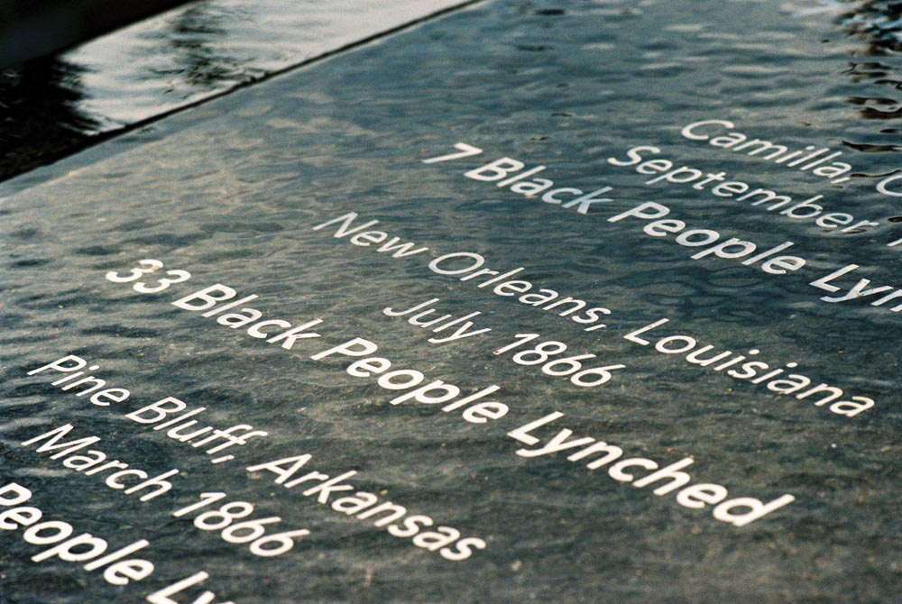 A closeup photo of the memorial outside the Legacy Museum that memorializes victims of racial terror lynchings and massacres during Reconstruction.