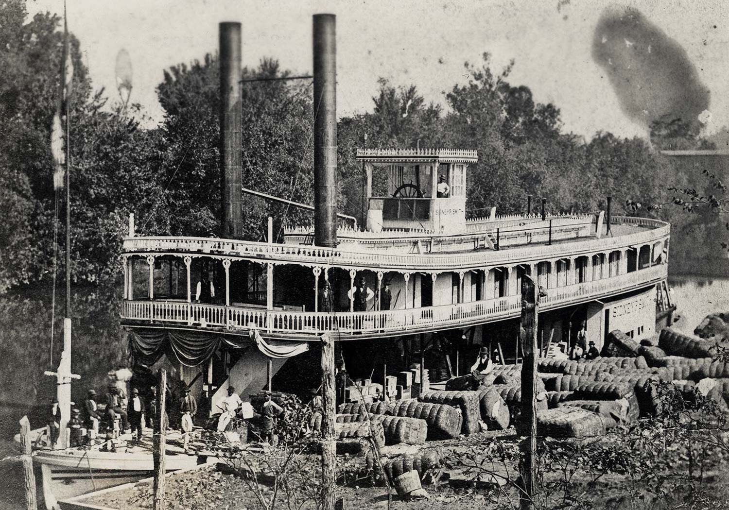 The steamboat Harriett being loaded with large bales of cargo on the Alabama River.