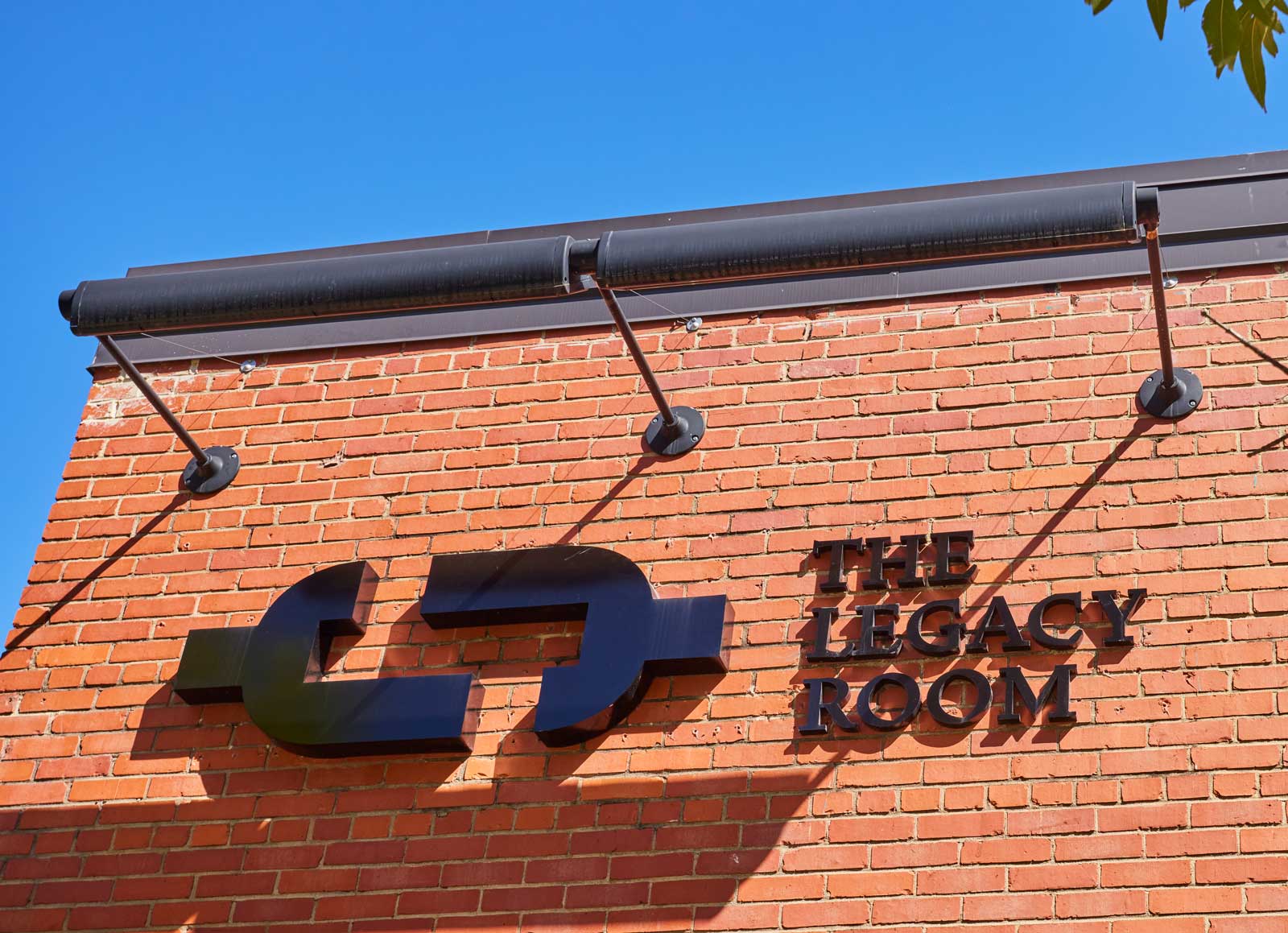 A sign on the red brick exterior identifies the Legacy Room, one of the meeting spaces that can be reserved for groups.